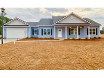 Charming one-story home with blue siding, white trim, and a well-manicured lawn at 3204 Fowler School Rd., Loris, SC 29569