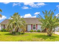 Charming one-story home with a well-manicured lawn and mature landscaping at 405 Flagstone Dr., Myrtle Beach, SC 29588