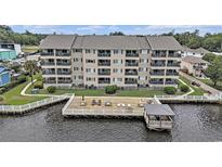 Beautiful condo complex with a wooden patio that extends over the water with furniture for relaxing and taking in the views at 4445 Kingsport Rd. # 101, Little River, SC 29566
