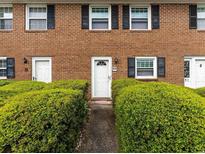 Charming brick townhouse featuring well-maintained landscaping and classic black shutters at 4505 N Kings Hwy. # E2, Myrtle Beach, SC 29577