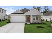 Charming single-story home with a gray exterior, well-manicured lawn, and a two-car garage at 4846 Hopespring St., Myrtle Beach, SC 29579