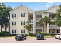 Inviting condo building featuring palm trees, well-manicured landscaping, and convenient parking at 601 Hillside Dr. N # 1931, North Myrtle Beach, SC 29582
