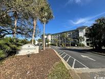 Attractive condo complex with lush landscaping and an inviting entrance at 601 Retreat Beach Circle # 521, Pawleys Island, SC 29585