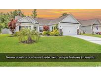 Charming single-story home with a well-manicured lawn and a neatly arranged garden at 832 Windsor Rose Dr., Conway, SC 29526