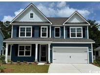 Charming two-story home with a symmetrical facade, a two-car garage, and a well-maintained front lawn at 137 Stride Ct., Myrtle Beach, SC 29588