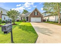 Charming brick home with a well-manicured lawn and a two-car garage at 1410 Bohicket Ct., Myrtle Beach, SC 29579