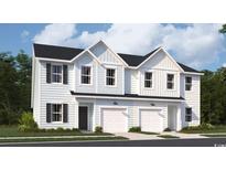 Charming townhome with black shutters, a single-car garage, and beautiful light-blue toned facade at 1704 Hunting Harris Ct # 1, Ocean Isle Beach, NC 28469