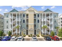 Attractive condo building with staircases, parking area, and well-maintained landscaping at 172 Ella Kinley Circle # 101, Myrtle Beach, SC 29588