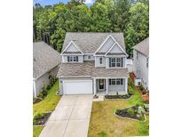 Charming two-story home with landscaped front yard and attached two-car garage in a neighborhood setting at 218 Calhoun Falls Dr., Myrtle Beach, SC 29579