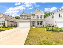 Charming two-story home featuring a well-manicured lawn and a classic architectural style at 218 Calhoun Falls Dr., Myrtle Beach, SC 29579