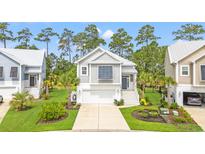 Charming coastal home featuring a two-car garage and well-manicured lawn at 277 Splendor Circle, Murrells Inlet, SC 29576