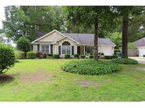 Charming single-story home with well-manicured lawn, lush landscaping, and inviting curb appeal at 3001 Dewberry Dr., Conway, SC 29527