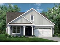 Charming home featuring vertical siding, a covered porch and an attached garage with a well-manicured front lawn at 532 Sheepbridge Way, Loris, SC 29569