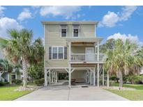 Stunning raised beach house with lush landscaping and covered parking, perfect for coastal living at 58 Fathom Ln., Murrells Inlet, SC 29576