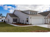 Charming single-Gathering home featuring a two-car garage, well-manicured lawn, and a classic light-gray facade at 7001 River Bridge Ct, Myrtle Beach, SC 29579