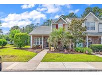 Charming townhouse with red shutters, brick accents, and well-manicured landscaping at 701 Wilshire Ln. # 0, Murrells Inlet, SC 29576
