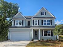 Charming two-story home with light blue siding, black shutters, and a well-maintained lawn at 768 Choctaw Dr., Conway, SC 29526