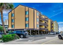 Coastal condo building featuring raised parking and private balconies with direct beach access at 806 N Waccamaw Dr. # 304, Garden City Beach, SC 29576