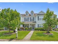 Charming two-story townhome with blue shutters, lush landscaping, and a well-manicured lawn at 816 Barn Owl Ct. # 816, Myrtle Beach, SC 29579