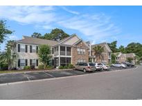 Charming condo with brick and siding, featuring screened porches and convenient parking at 9 Pistachio Loop # D, Murrells Inlet, SC 29576