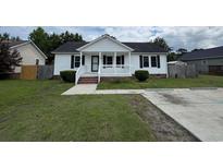 Charming one-story home with white siding, a cozy front porch, and a well-maintained lawn at 1041 Morning Dale St., Conway, SC 29526