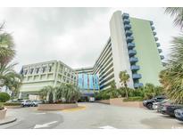 Inviting entrance to Coral Beach Resort with well-maintained landscaping and ample parking at 1105 S Ocean Blvd. # 932, Myrtle Beach, SC 29577