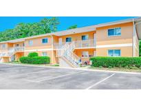 Exterior view of the condo with parking space and lush landscaping at 1200 5Th Ave. N # 1207, Surfside Beach, SC 29575