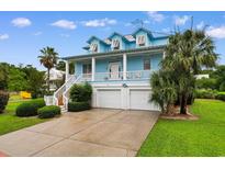 Charming coastal home with a two-story porch, three dormers, and a spacious three-car garage at 141 Cayman Loop, Pawleys Island, SC 29585