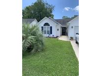Charming single-story home with well-manicured lawn and palm trees at 1432 Seahouse Ct., Surfside Beach, SC 29575