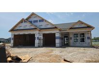 New construction home featuring a two-car garage and classic architectural design still under construction at 1531 Breakwater Dr., Little River, SC 29566