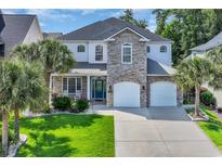 Beautiful two-story home with a stone facade and well-maintained landscaping and two-car garage at 1619 Eastover Ln., North Myrtle Beach, SC 29582