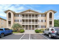 Three-story condo complex showcasing private balconies and well-manicured landscaping at 1900 Duffy St. # L4, North Myrtle Beach, SC 29582
