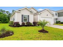 Charming home exterior shows manicured lawn, dark shutters, and attached one car garage at 211 Pine Forest Dr., Conway, SC 29526