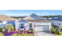 Charming single-story home with a well-manicured lawn and beautiful flowerbeds adding curb appeal at 2653 Orion Loop, Myrtle Beach, SC 29577