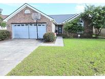 Charming single Gathering house featuring an attached garage, well-manicured lawn, and lovely curb appeal at 2707 Canvasback Trail, Myrtle Beach, SC 29588