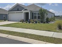Charming single-story home with a well-manicured lawn and attached two-car garage in a residential community at 297 Harvest Ridge Way, Conway, SC 29527