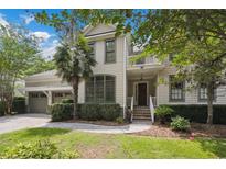 Charming two-story home with manicured lawn, brick stairs, and a welcoming front porch at 346 Tuckers Rd. # A, Pawleys Island, SC 29585