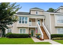 Inviting two-story townhouse with stairs to front porch, well-maintained lawn and landscaped garden at 3833 Myrtle Pointe Dr. # 18 Bu 3, Myrtle Beach, SC 29577