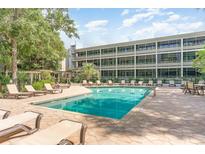 Inviting outdoor pool and lounge area with ample seating and well-maintained landscaping at 415 Ocean Creek Dr. # 2372, Myrtle Beach, SC 29572