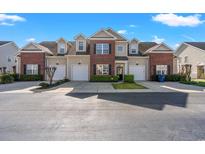 Charming townhome with brick accents, a private entrance, garage and manicured landscaping at 4378 Willoughby Ln. # 4378, Myrtle Beach, SC 29577