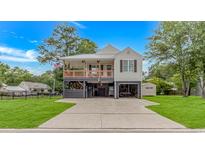 Charming coastal home with a covered porch, spacious driveway, and well-maintained lawn at 4600 Murrells Inlet Rd., Murrells Inlet, SC 29576