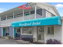Charming two-story condo building featuring a distinctive blue awning and prominent street numbers at 5409 N Ocean Blvd. # 100, North Myrtle Beach, SC 29582