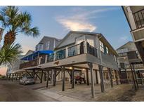 Charming elevated beach home with covered parking and a spacious balcony, perfect for coastal living at 6001 - 1082 S Kings Hwy., Myrtle Beach, SC 29575