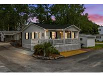 Charming beach cottage with a lovely front porch and landscaped yard at 6001-1808 S Kings Hwy., Myrtle Beach, SC 29575