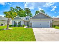 Charming single-story home featuring a two-car garage, well-manicured lawn and mature trees, a lovely place to call home at 631 Rycola Circle, Surfside Beach, SC 29575