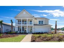 Charming two-story home with a welcoming front porch and manicured lawn at 7139 Shooting Star Way, Myrtle Beach, SC 29579