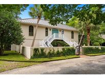 Stunning two-story home with white stairs, lovely gated entry, and lush landscaping at 95 Sanderling Ave., Georgetown, SC 29440