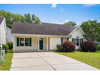 Charming single-story home featuring a well-maintained lawn and inviting green shutters and door at 9580 Kings Rd., Myrtle Beach, SC 29572