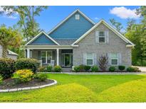 Charming brick home with blue accents, manicured lawn, and inviting front porch at 1051 Academy Dr., Conway, SC 29526