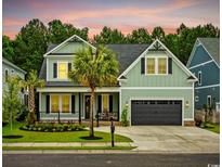 Charming two-story home featuring a manicured lawn, two-car garage and beautiful palm trees at 1058 East Isle Of Palms Ave., Myrtle Beach, SC 29579